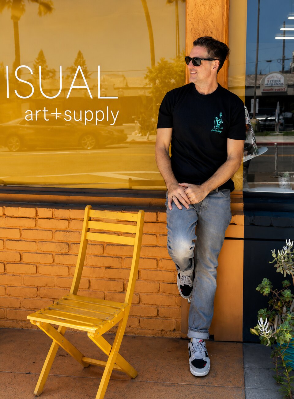 Jason Gould, artist, founder and owner of VISUAL, outside the shop on 30th Street