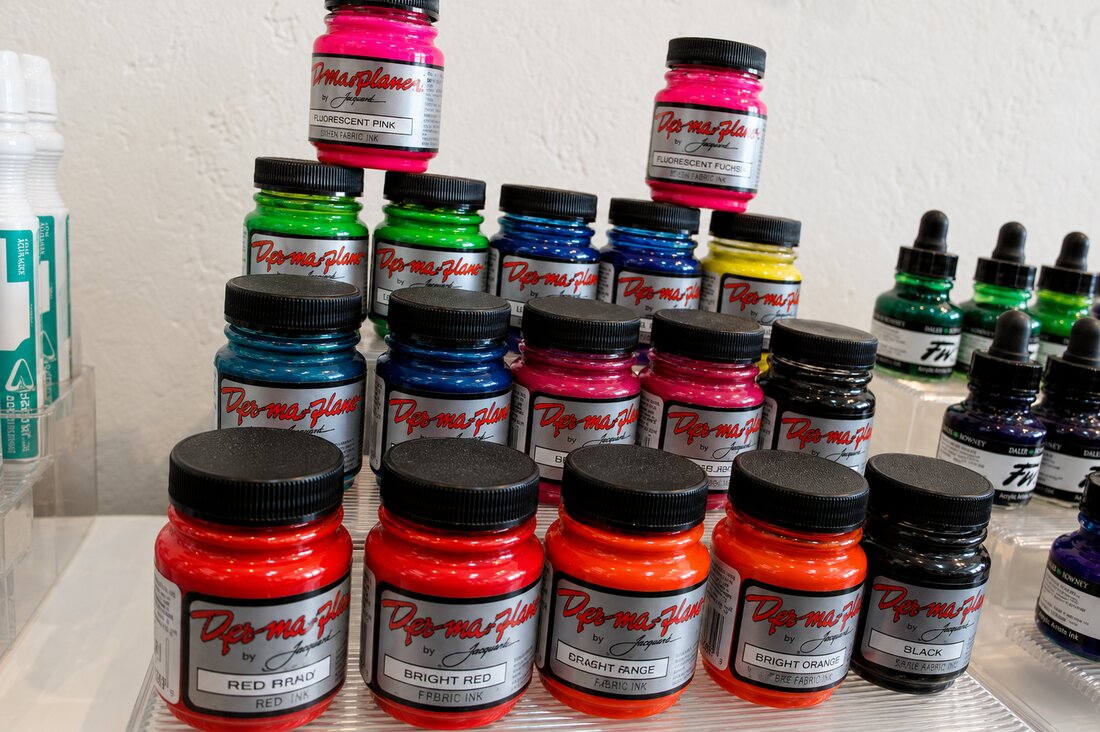 Bottles of colorful fabric and acrylic ink at VISUAL art supply